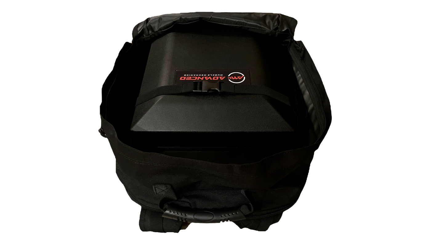 Top-down view of Advanced Muscle Mechanics Launch Pad inside a tactical backpack, showing compact storage with buckle strap for secure transport.