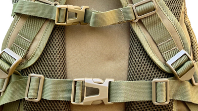 Close-up of chest and waist straps with mesh padding on the unbranded tactical backpack, highlighting durable buckles and adjustable webbing for secure fit and comfort.