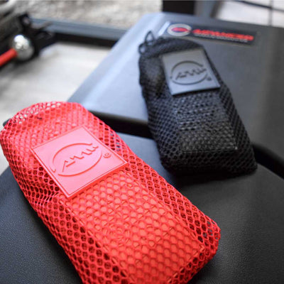 Advanced Muscle Mechanics Premium Wrist Wraps in matching red and black mesh drawstring bags, offering breathable storage for convenient transport and workout support.