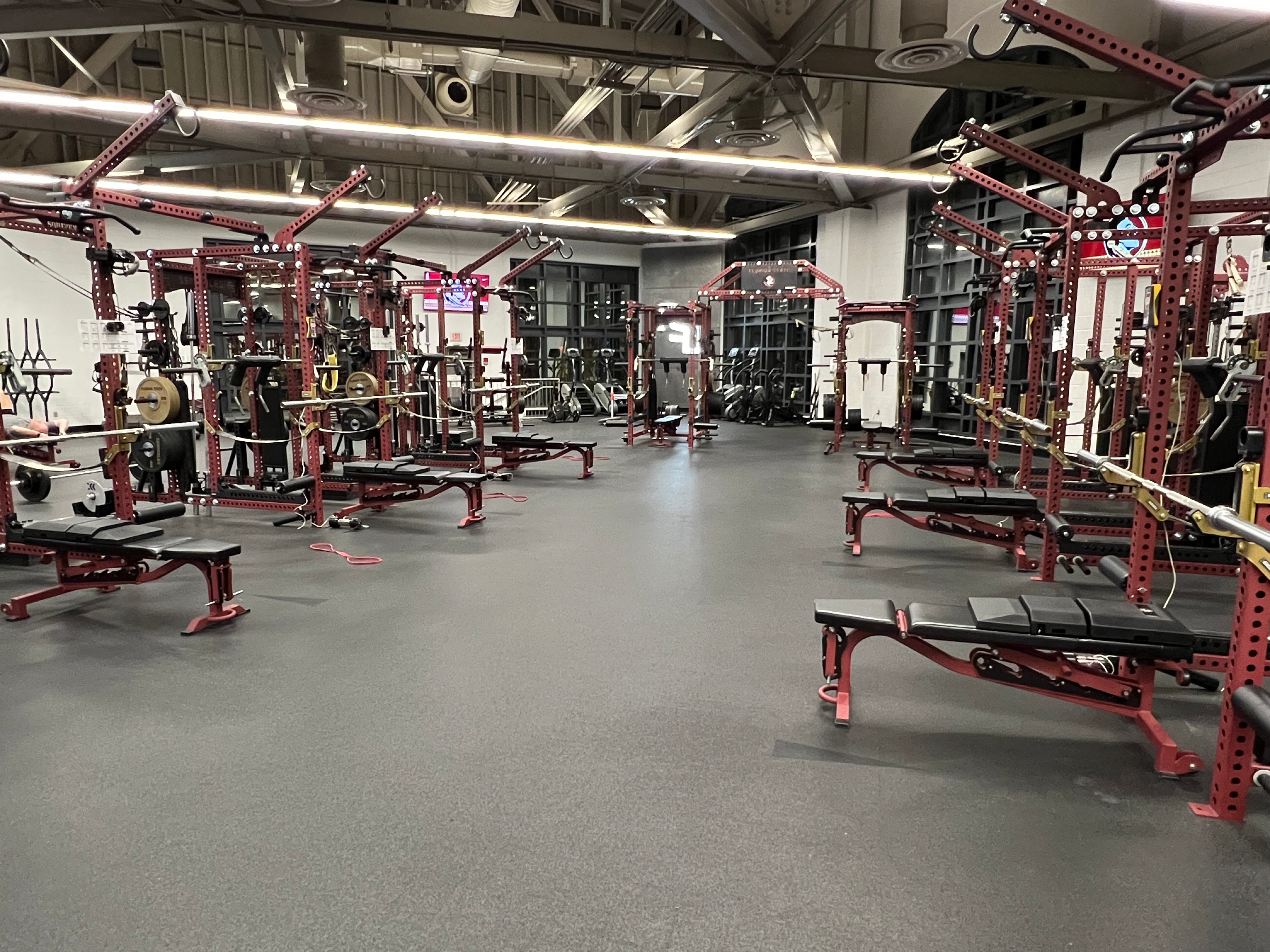 Frontal side view of six Florida State University custom Launch Pads™ installed on benches in a collegiate strength training room.