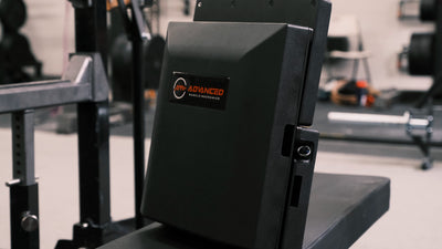 The Launch Pad™ folded with the Advanced Muscle Mechanics logo visible, showcasing its compact design and portability for strength training