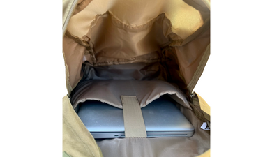 Main compartment interior of unbranded tactical backpack featuring padded laptop sleeve with secure strap, providing protection for electronics on the go.