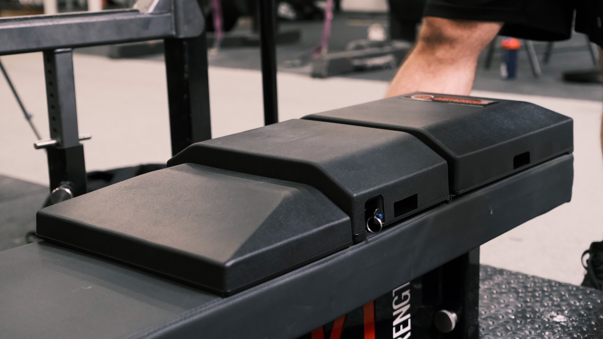 The Launch Pad secured to a bench, highlighting its ergonomic design to enhance stability, optimize range of motion, and improve alignment for superior strength training performance.