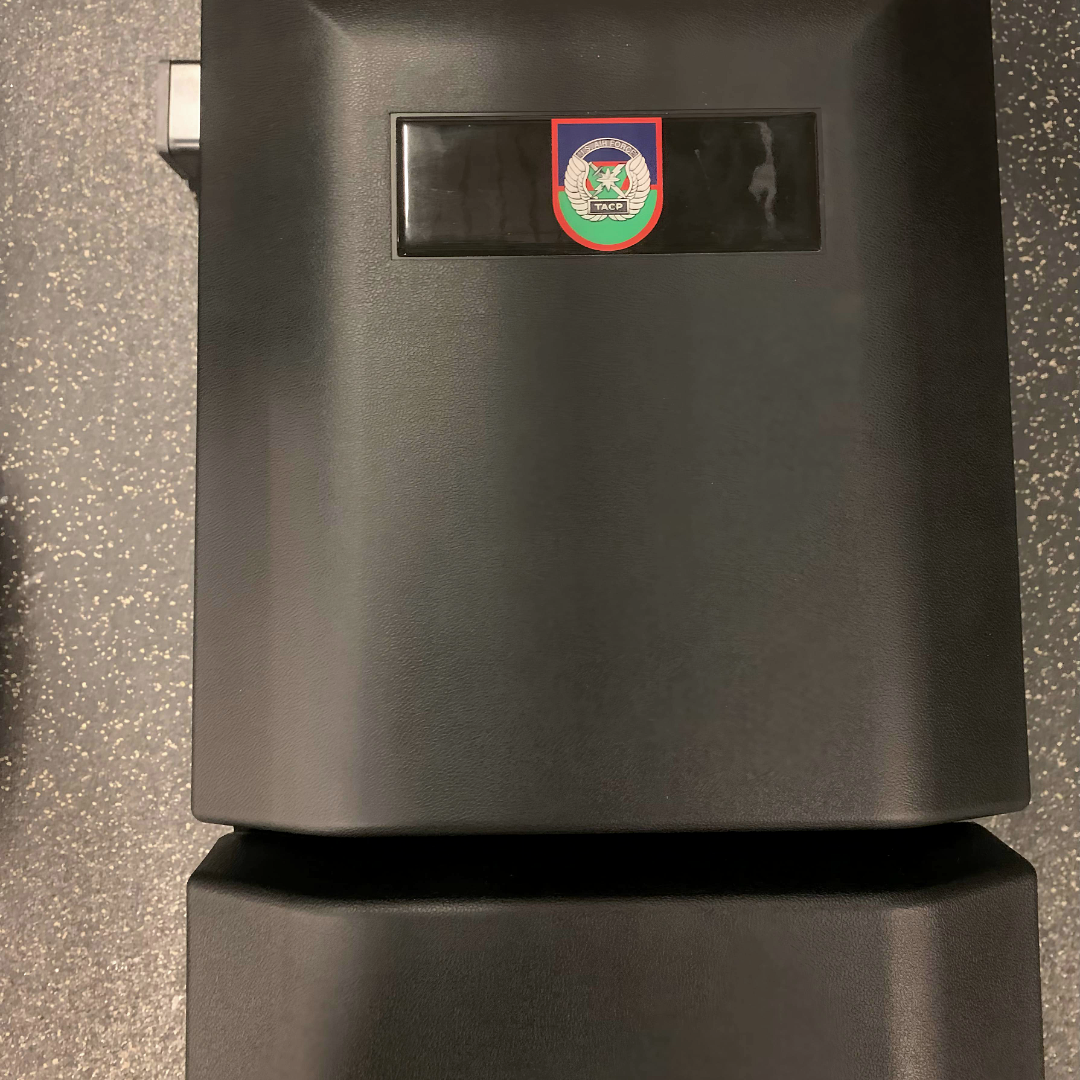 Close-up of a custom-branded version of The Launch Pad® with a black-and-gray insignia.