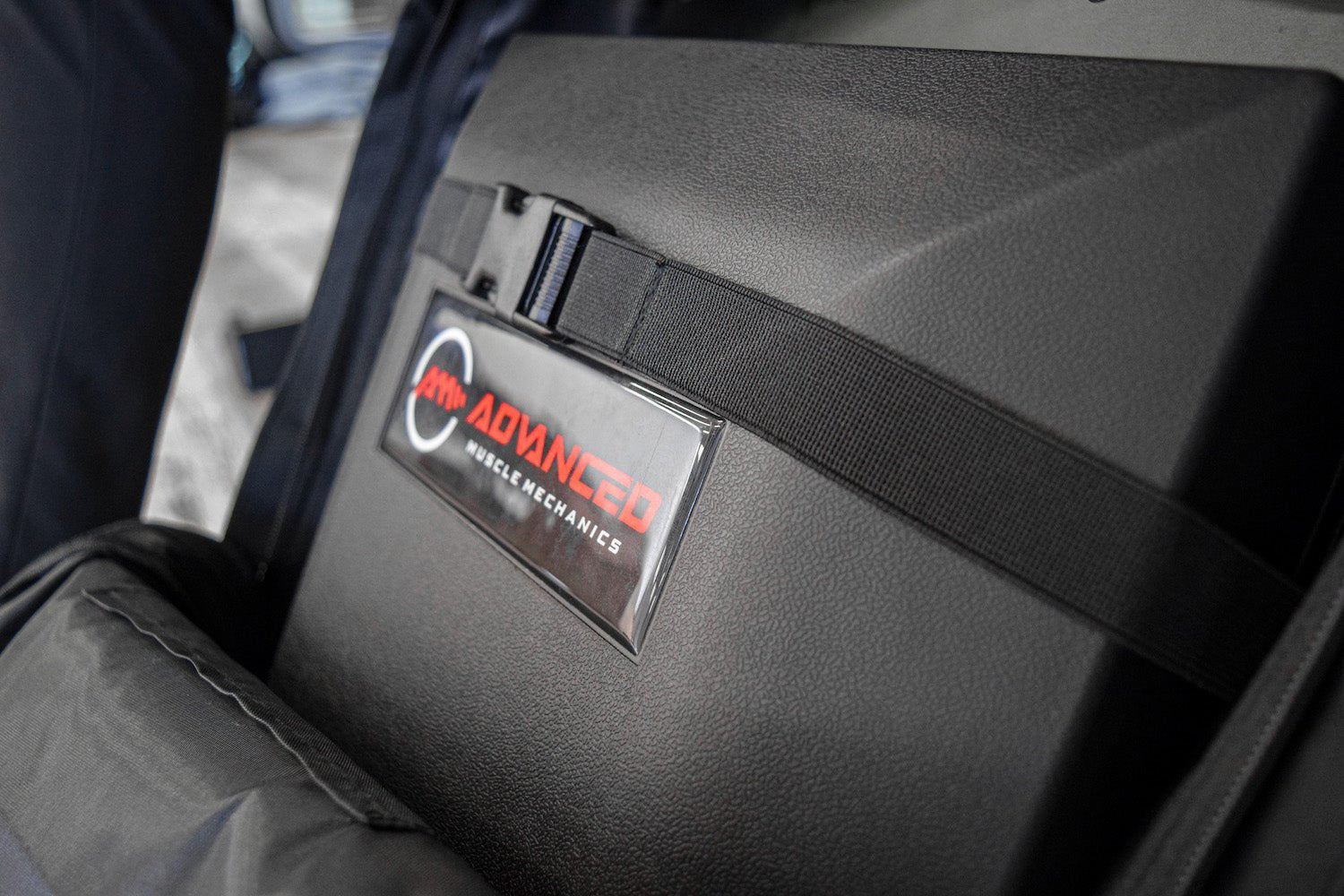 Close-up of a black carrying strap secured across The Launch Pad® inside the backpack.