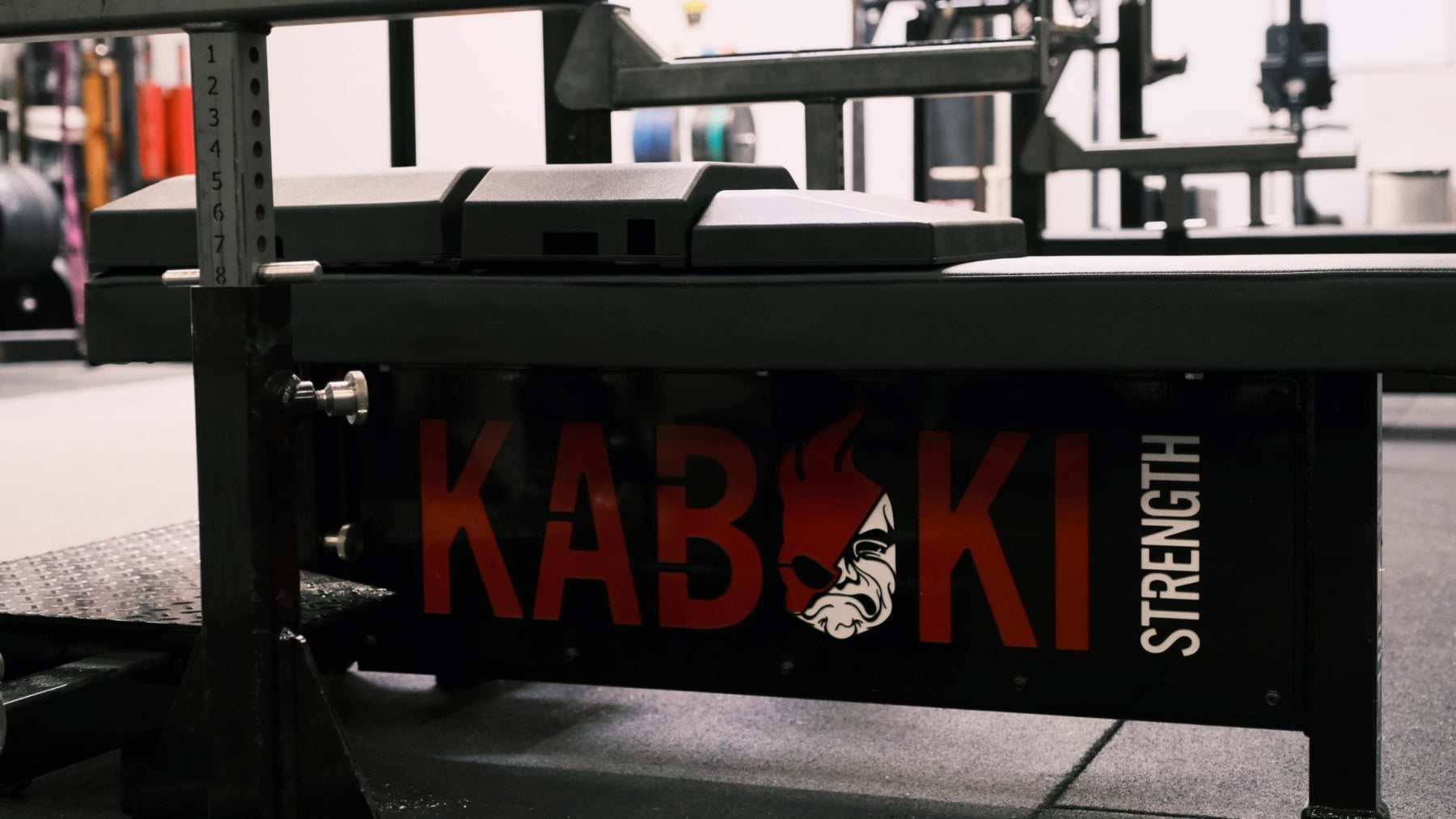 Side-profile view of The Launch Pad® on a flat bench above a black bench frame.