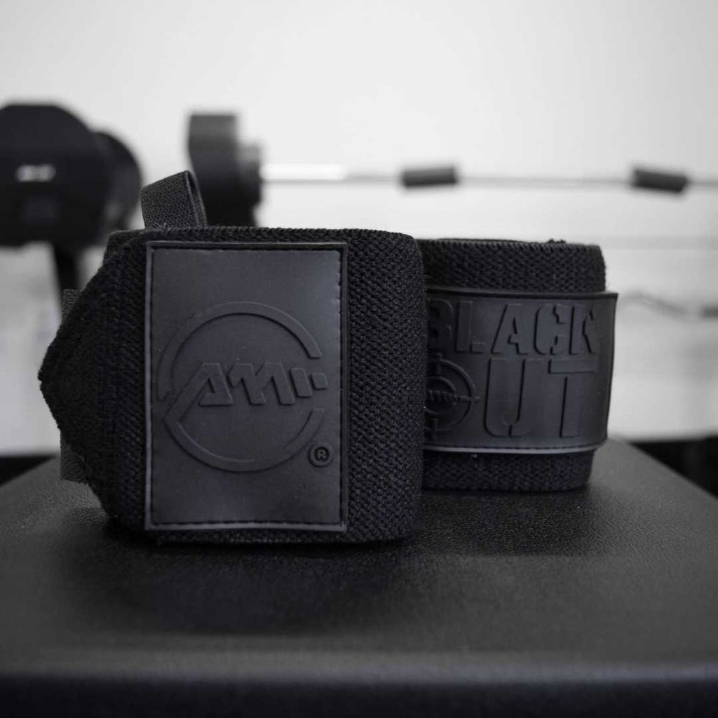 Durable Black Out premium wrist wraps from Advanced Muscle Mechanics, designed for superior wrist support and stability during heavy lifting.