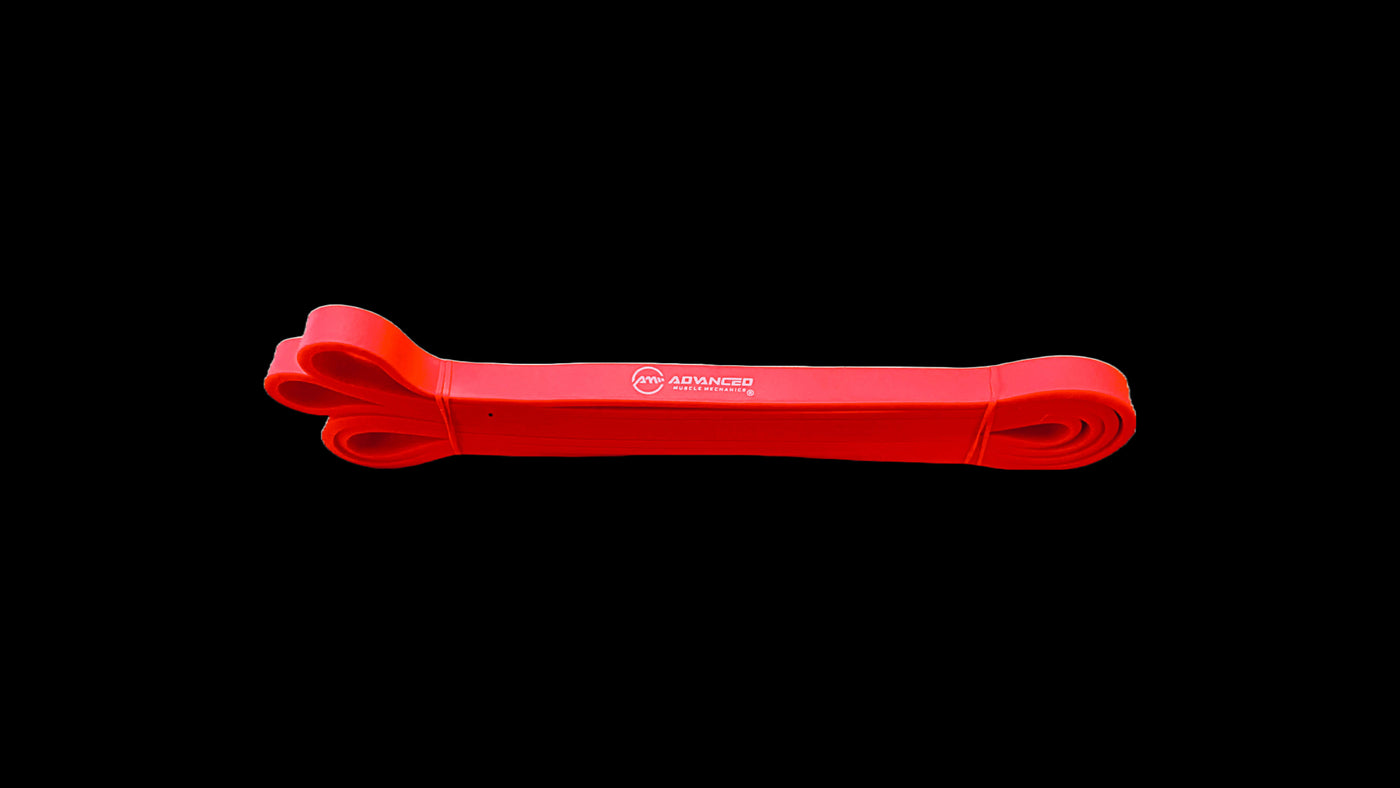 Red resistance band by Advanced Muscle Mechanics, ideal for mobility, strength training, and muscle activation exercises.