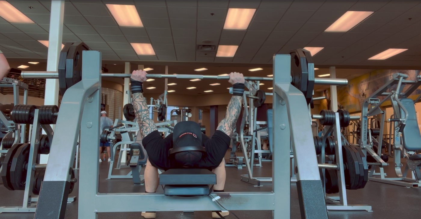 Athlete bench pressing with full extension on The Launch Pad, optimizing alignment and muscle activation for enhanced strength training performance.